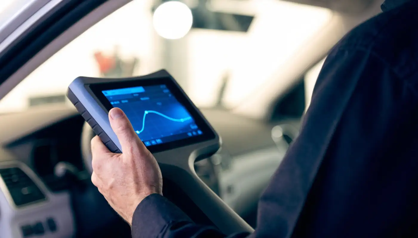 Diagnostic scanner plugged in under the dashboard